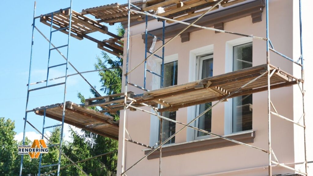 Scaffolding on pink stucco building